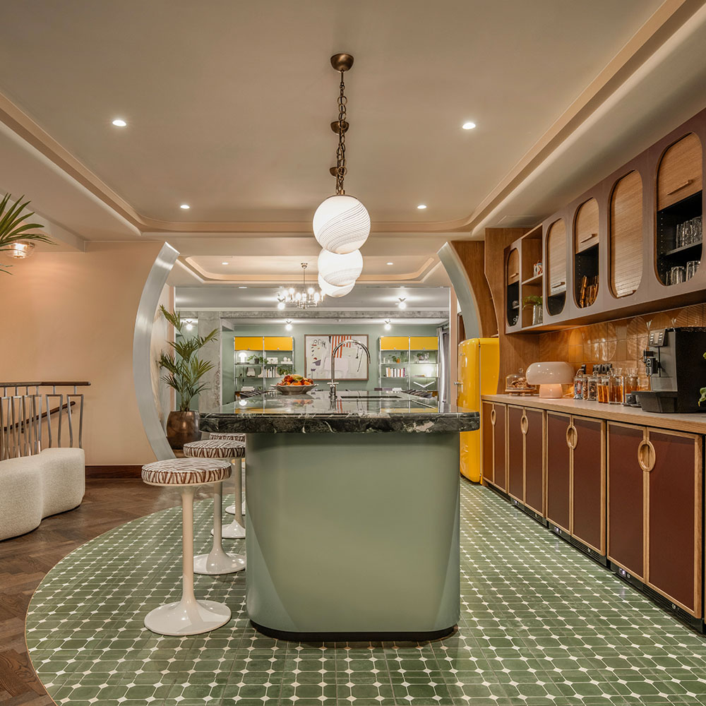 Side view of kitchen island, in the pantry, with bar stools.