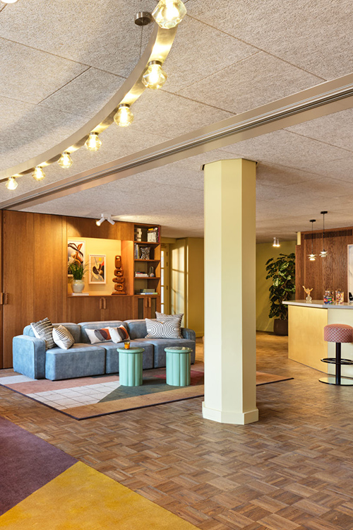 Interior of the pantry space with funky overhead lighting and sofas and stools