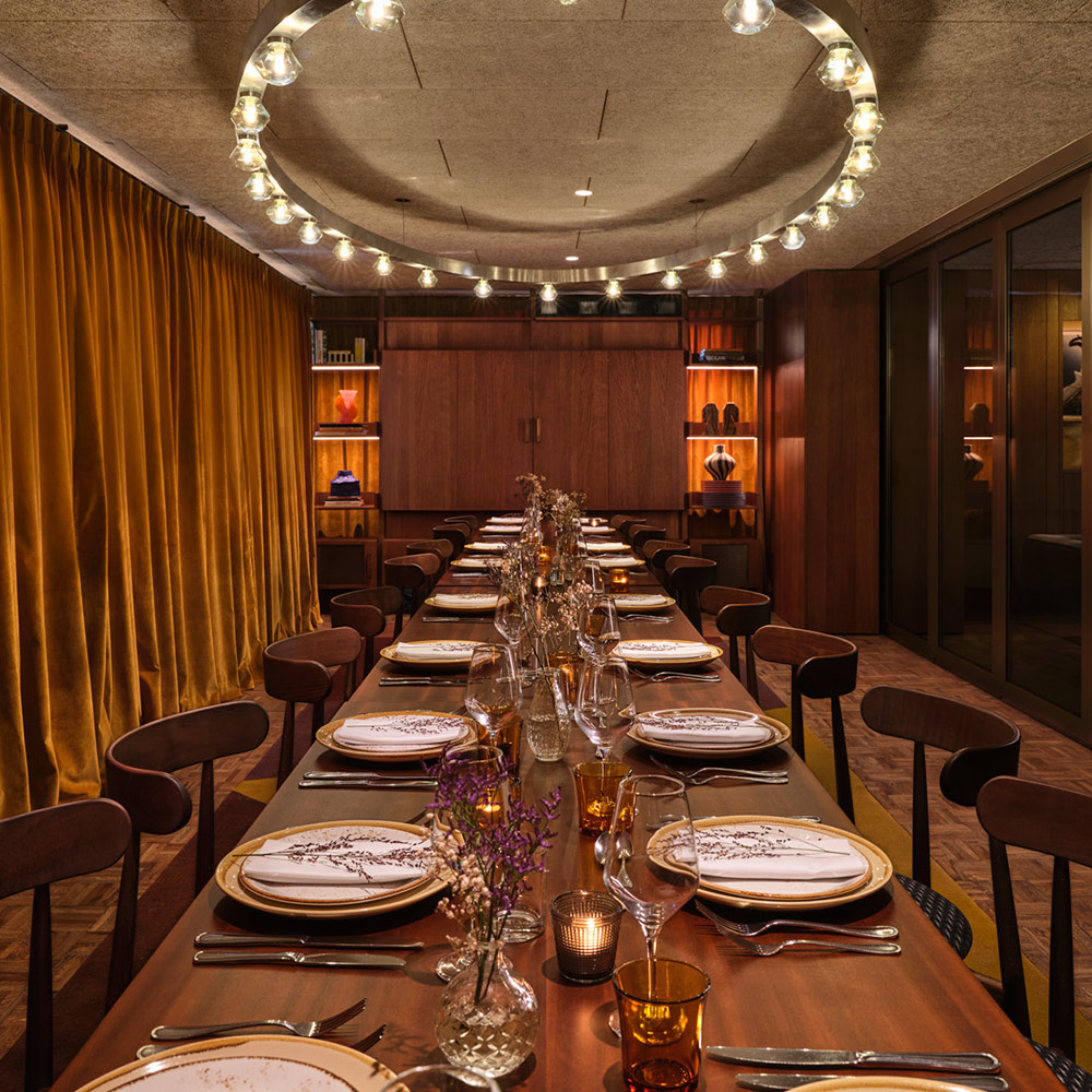 View down a long table laid out on both sides for a private dinner