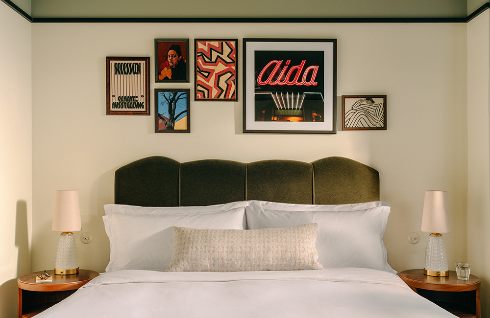 View of the big beautiful bed with art on the wall behind.