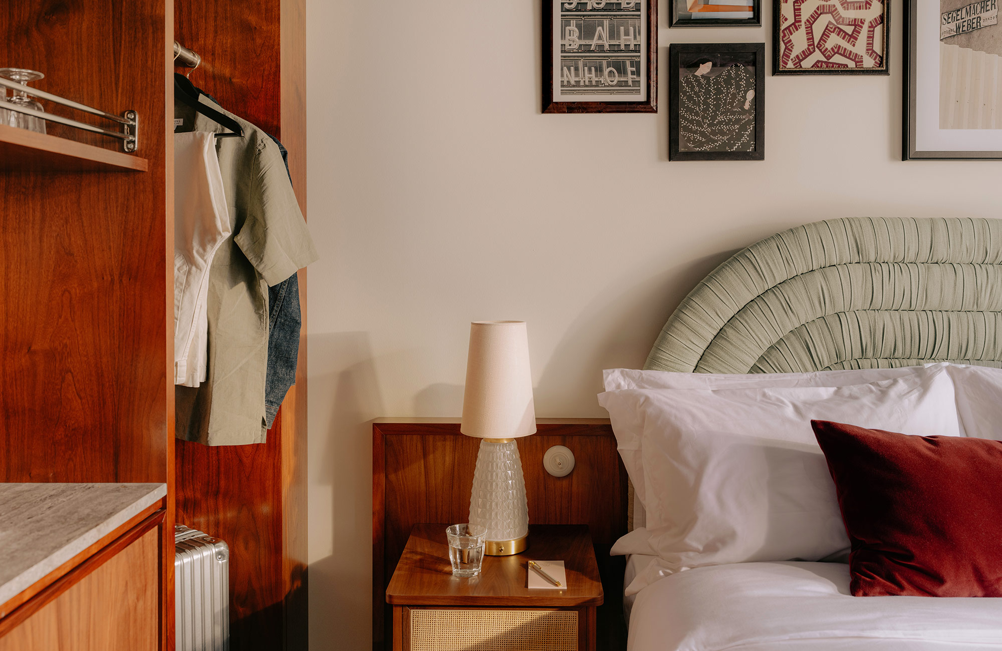 Left side of the bed with bedside lamp and open wardrobe with plenty of storage space