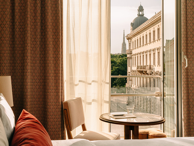 View of Vienna through an open window at Hoxton Vienna