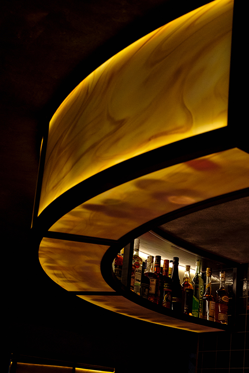 lit up hanging yellow alabaster bar shelf.