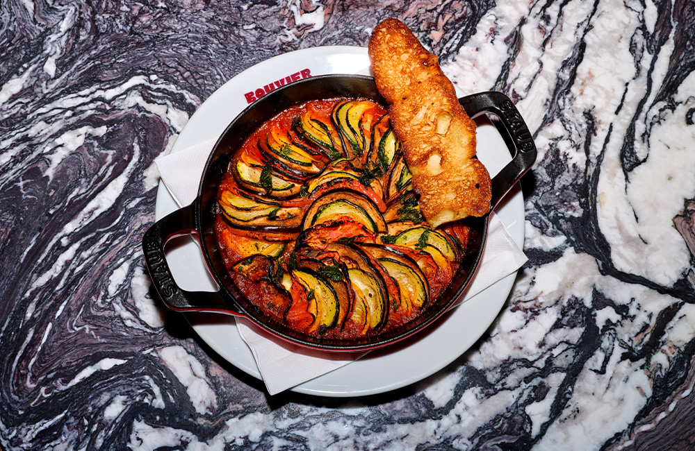 ratatouille served in a deep skillet and bread.