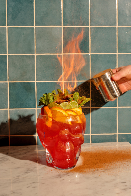 Giant glass skull filled with the drink 'where's your head at?' which is on fire.