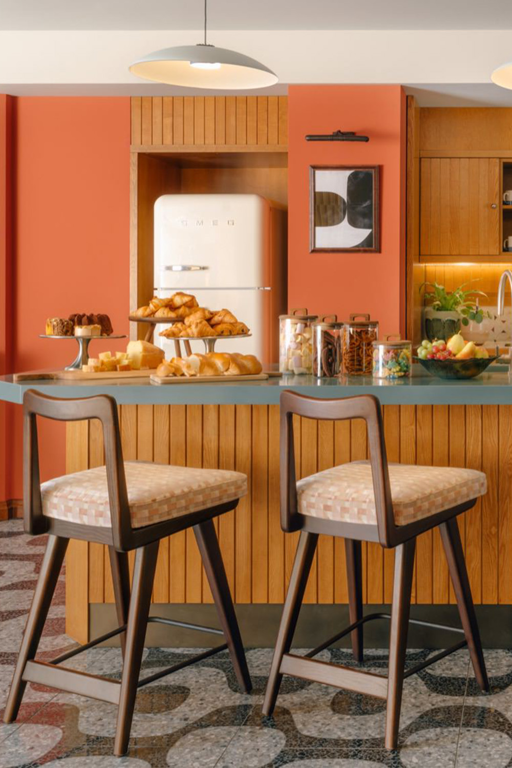 Counter in the pantry with two bar stool and food and beverages on the counter top.