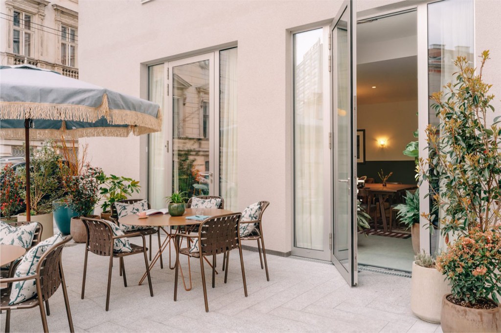 Terrace space showing parasol, table and chairs.