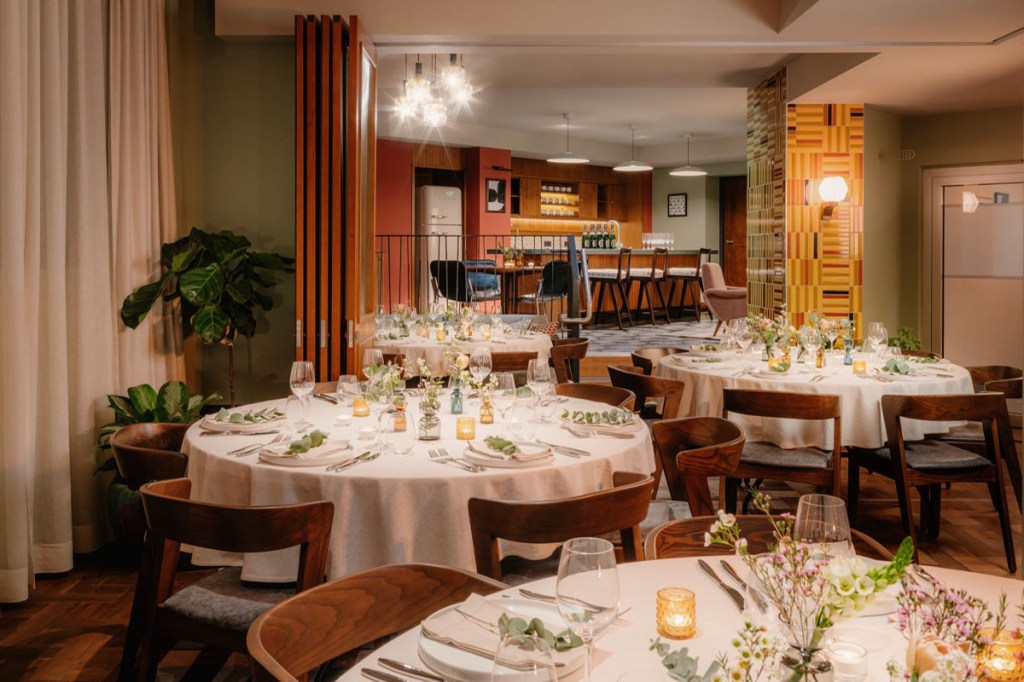 3 round tables in the den, decorated with white table cloth and flower,for private event.