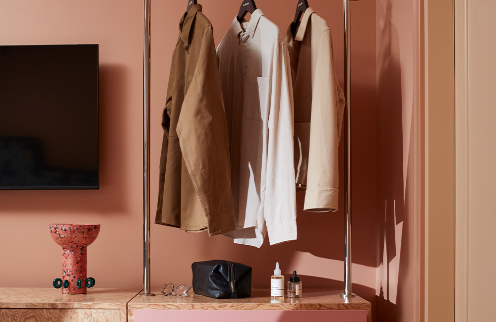 Open storage unit featuring shelves and a hanging section for storage and organisation