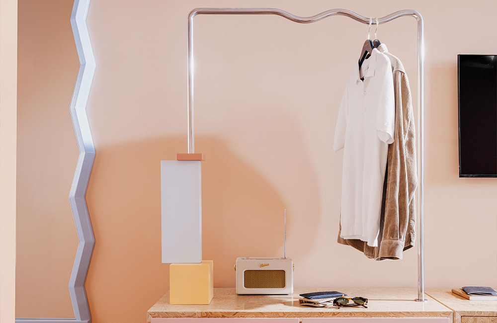 Open storage unit featuring shelves and a hanging section for storage and organisation