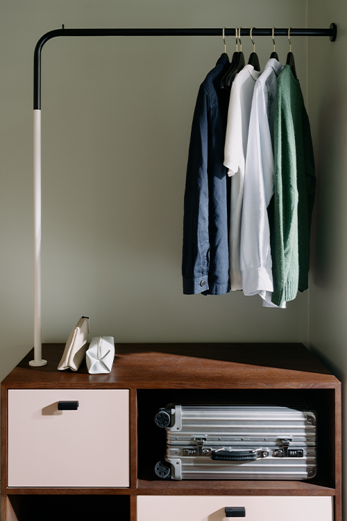 Open storage unit featuring shelves and a hanging section for storage and organisation.