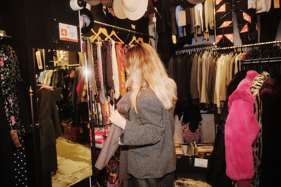 Photos by Ben Hickman. Woman browsing clothes inside store. - The Localist, Hoxton Hotels.