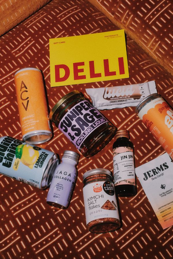 Gut Delli products spread all over a soft furniture seat.