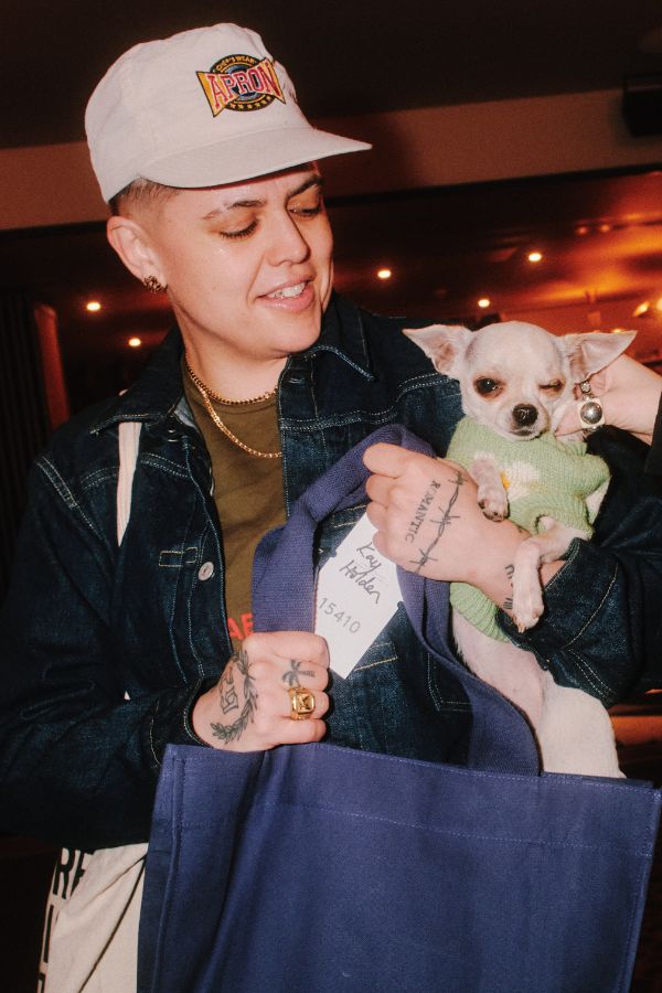 A person holding a small dog.