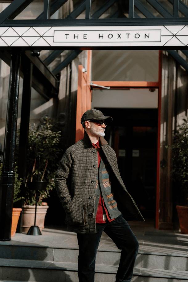 Man stands on steps outside Hoxton Hotel